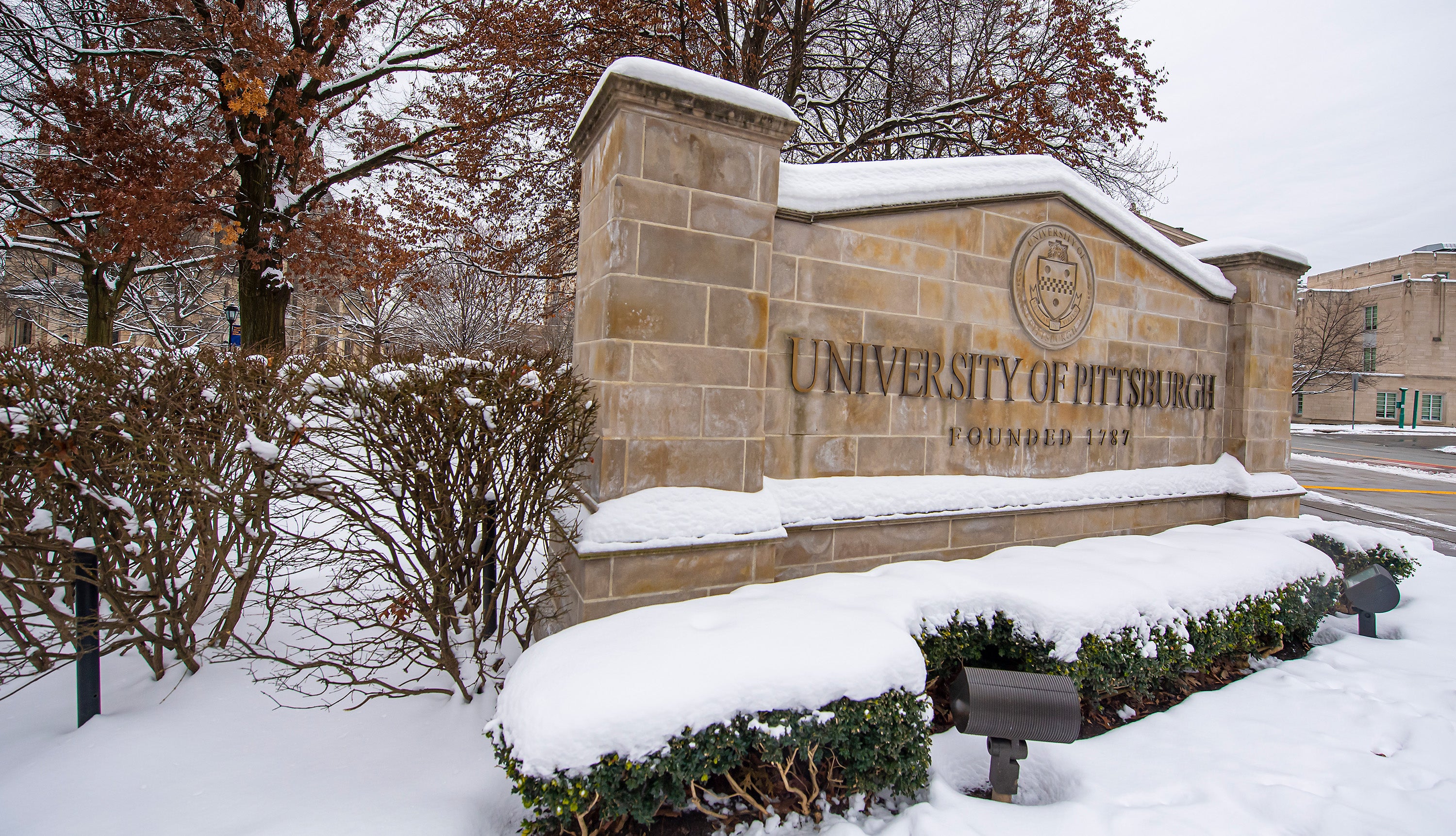 The University of Pittsburgh sign on a snowy day