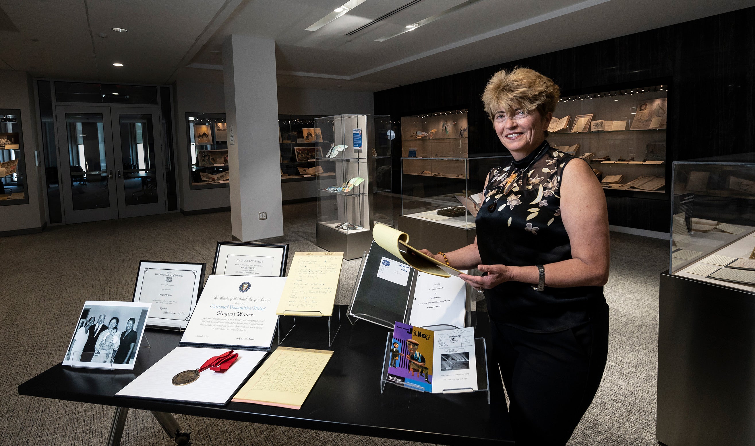 Tancheva handles a legal pad next to a table of artifacts