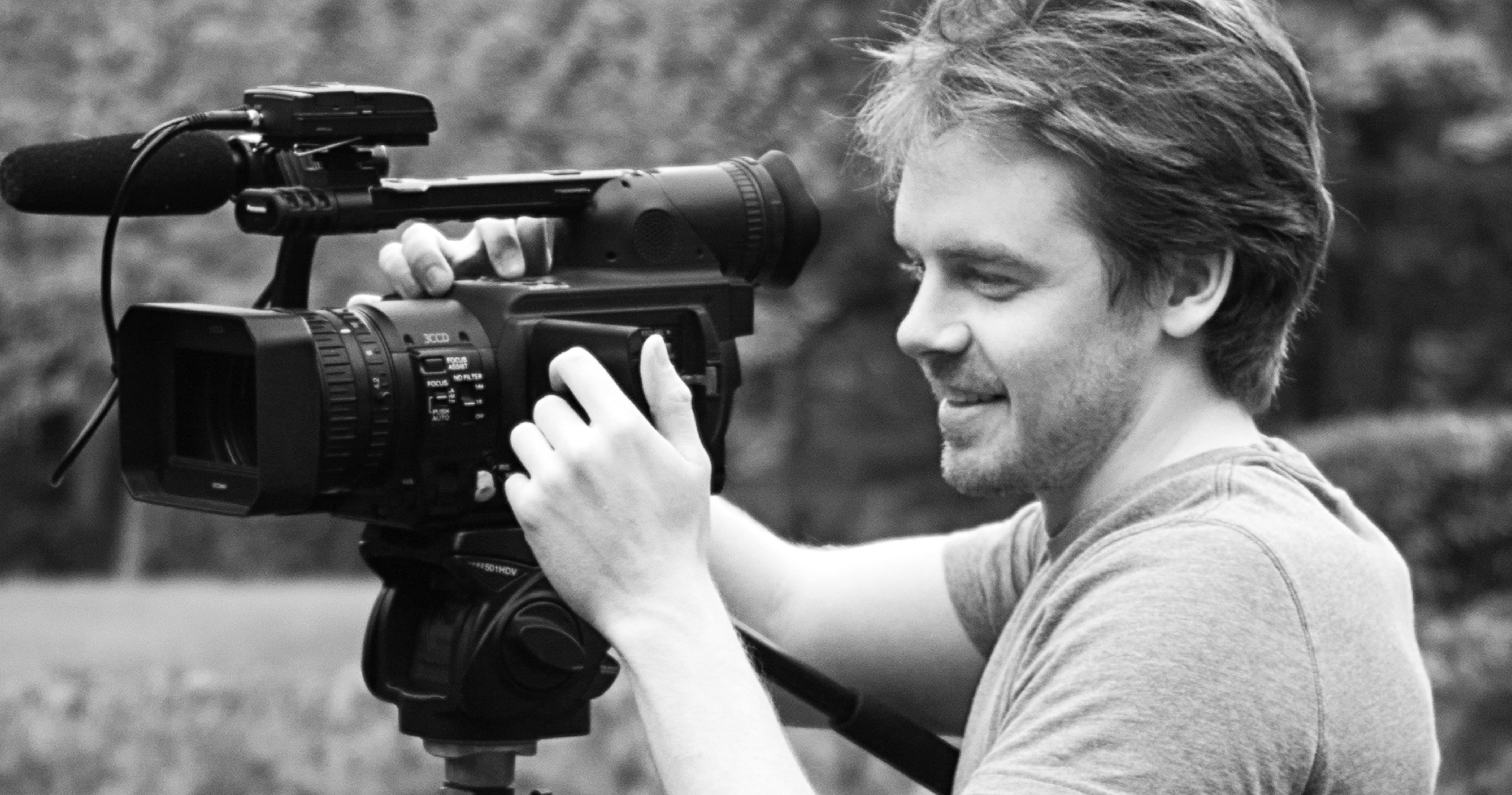 Tom Getty handles movie camera on a stand on set