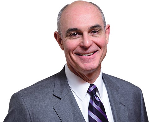 white man in gray suit and pink, blue, and navy striped tie