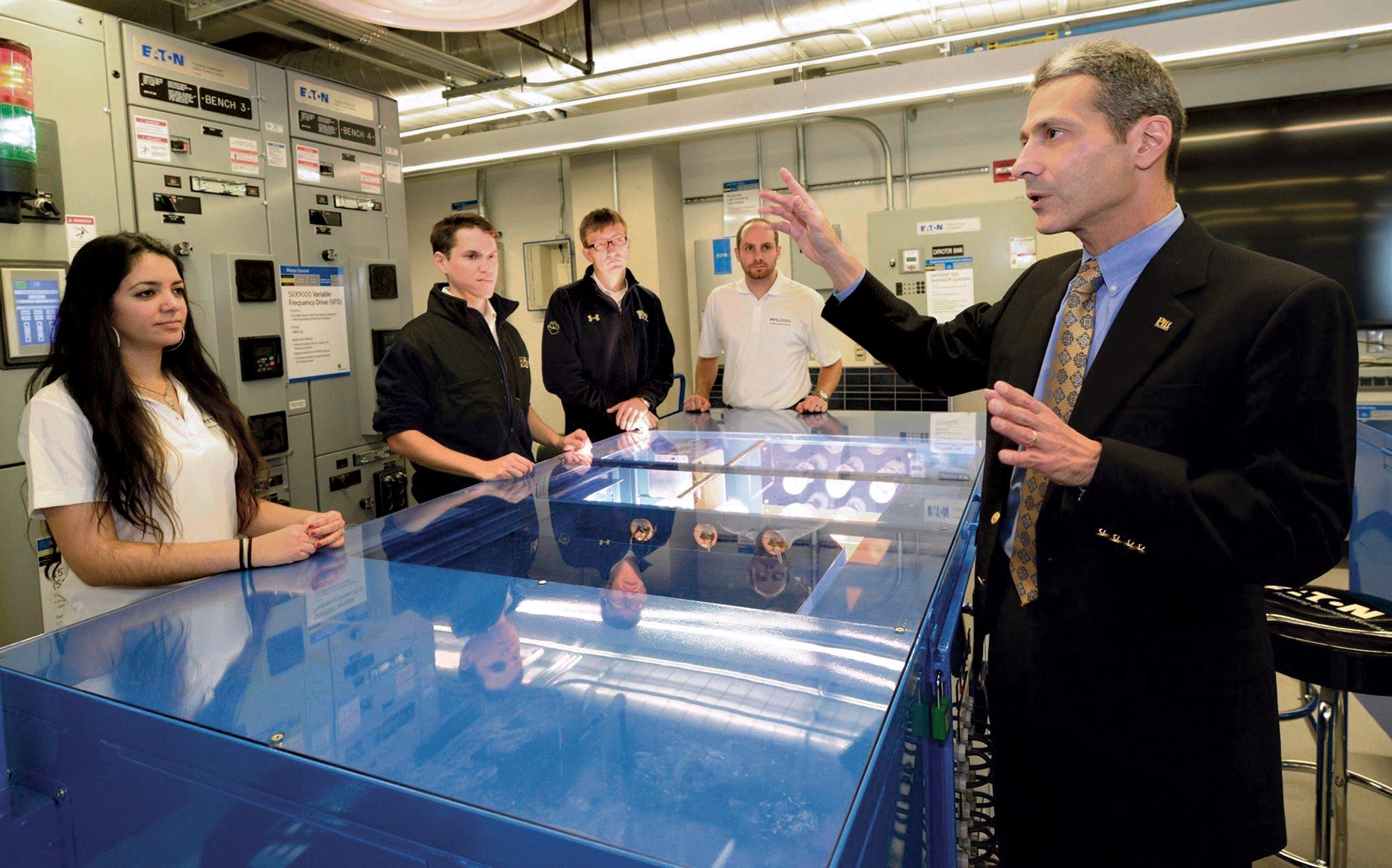 Gregory Reed talks with students in a lab setting.