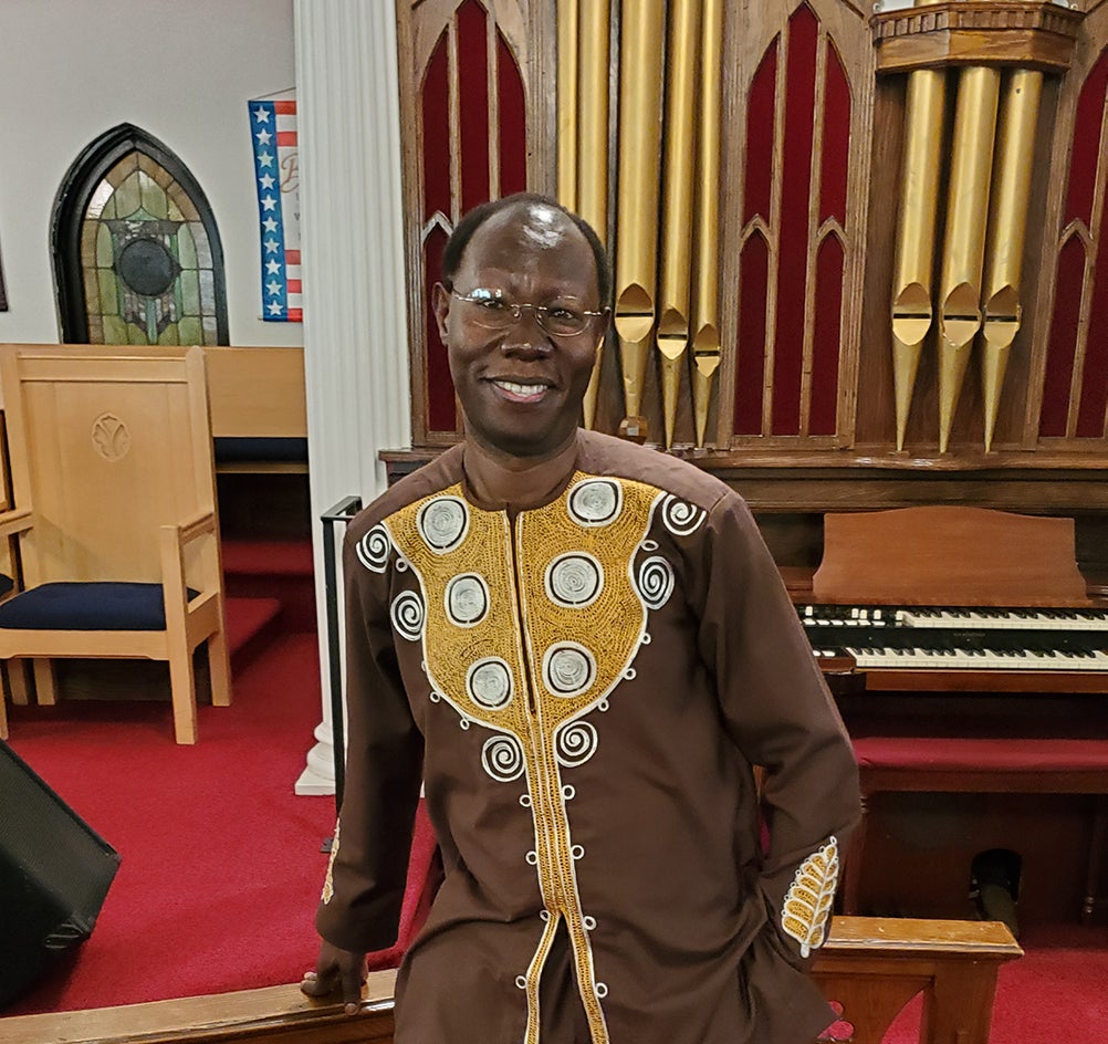 man standing in front of church organ