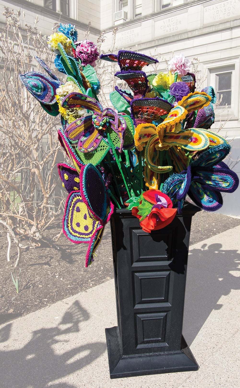 Homemade, multicolored flowers in a vase outside of the Carnegie Library of Pittsburgh Main.