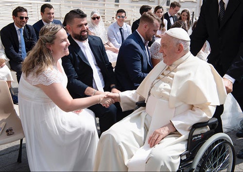 Pope Francis meets a bride and groom