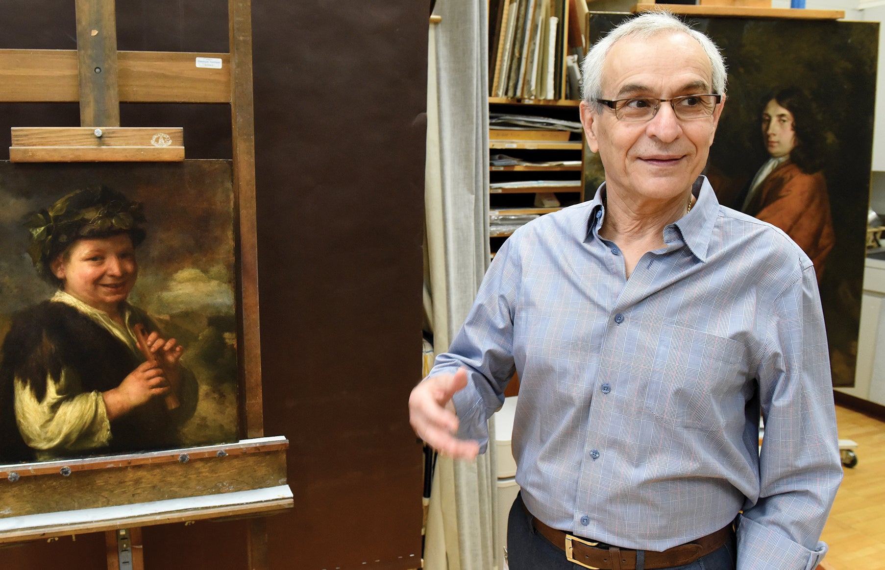 Costas Karakatsanis stands next to and discusses the 18th-century painting Shepard Boy with Recording at the Carnegie Museum of Art in Pittsburgh. 