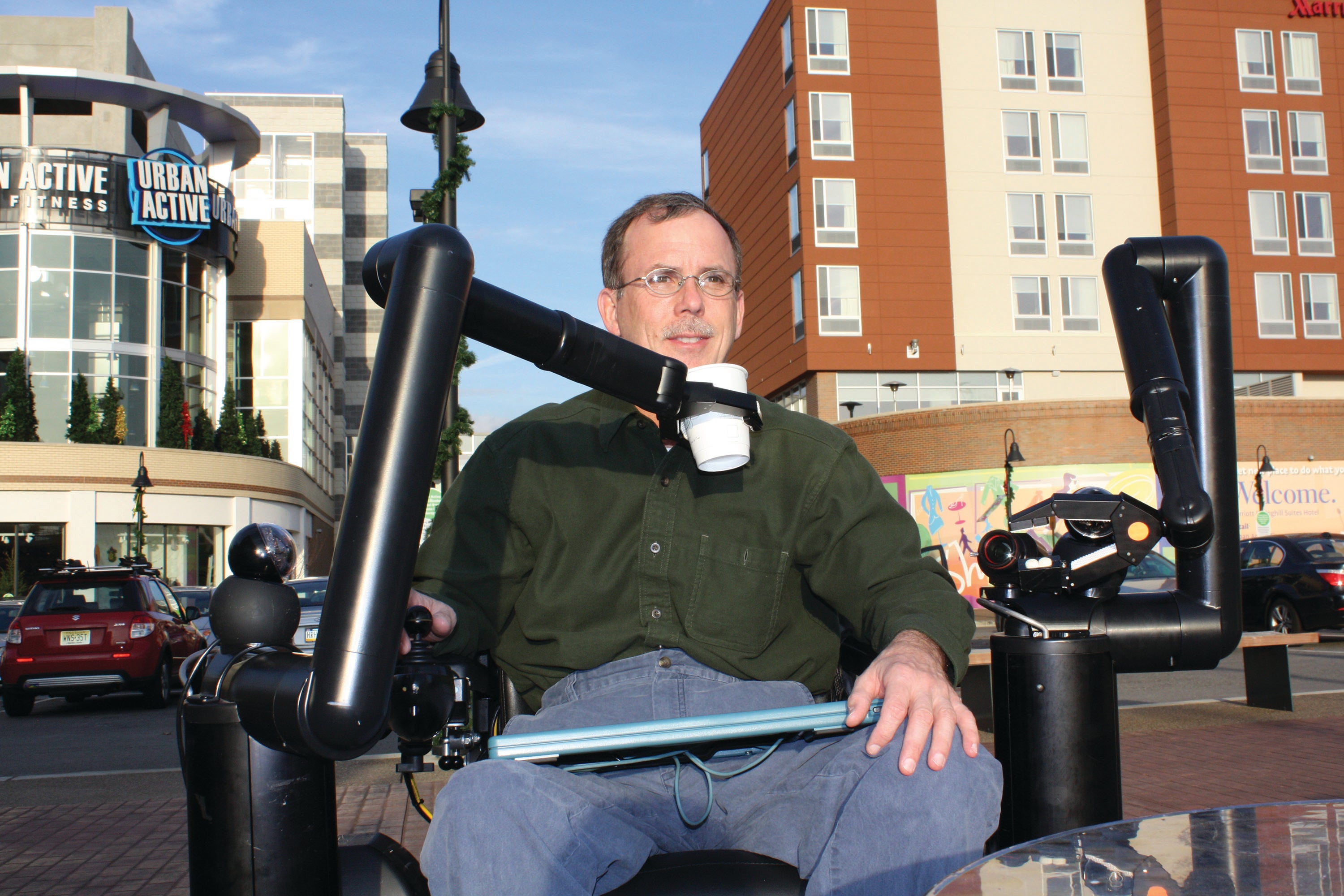 Cooper enjoys a drink using the Personal Mobility and Manipulation Appliance