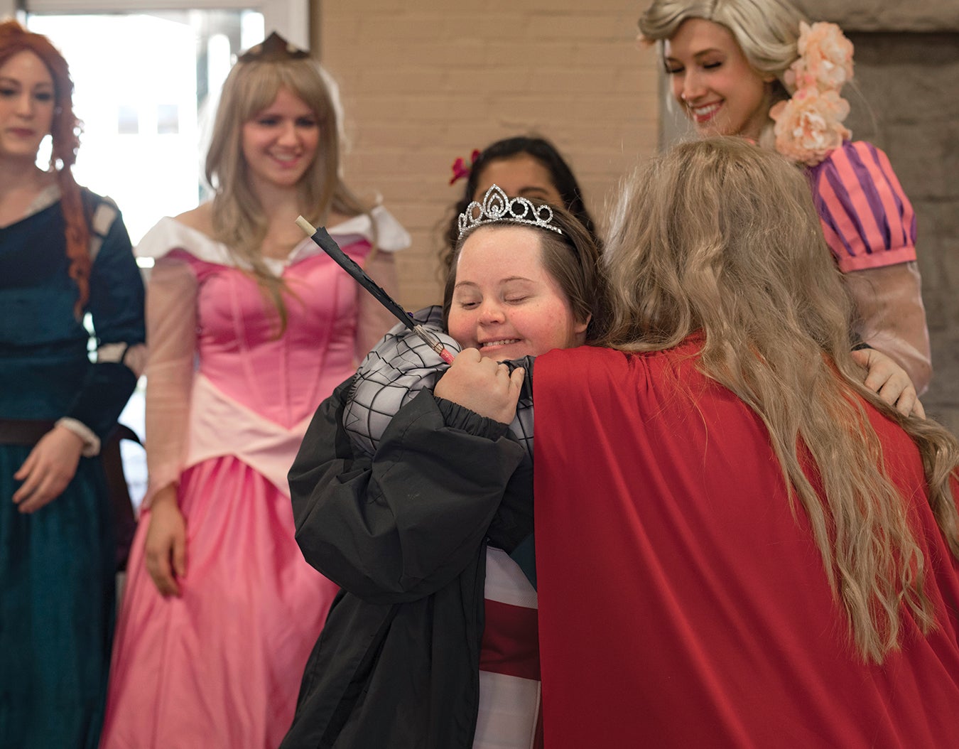 Andrea receives a superhero hug from marketing major Caleb Shalaby.