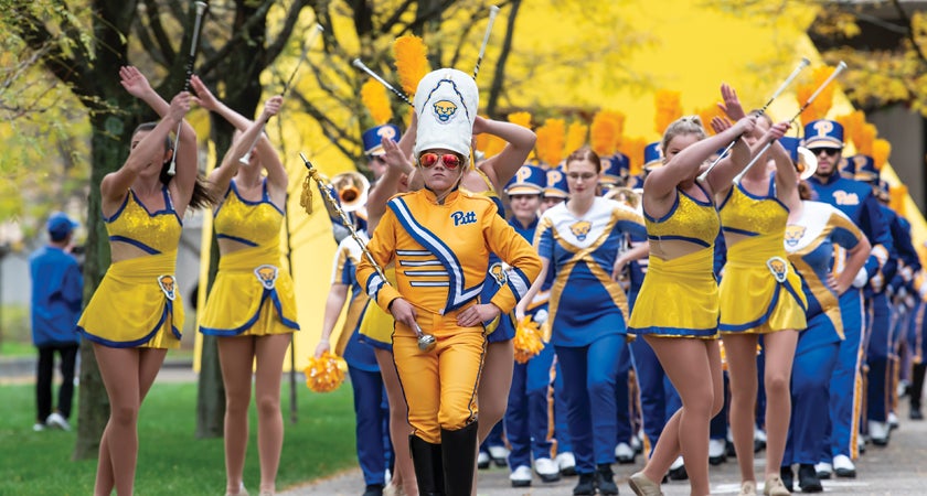 Drum Major Crissy Shannon leads the band through campus in 2019.