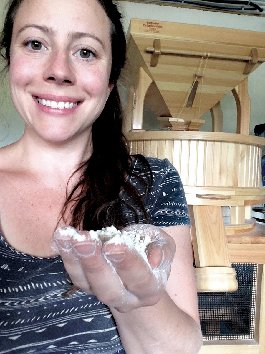 Shana Slossberg holds a handful of baking flour.