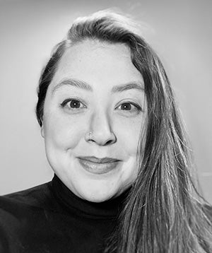 Black and white photo of woman with long hair wearing dark shirt