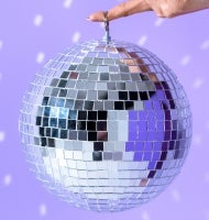 A disco ball held aloft by one finger