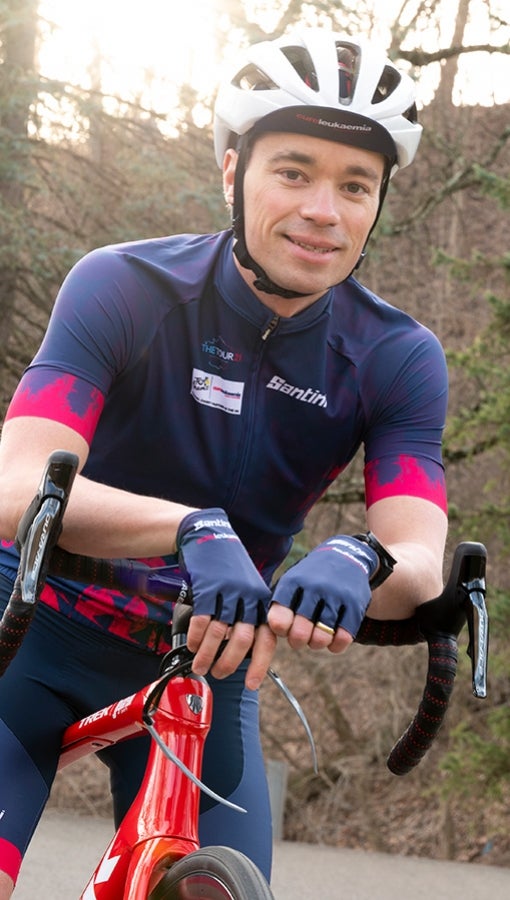 Ian MacFawn smiles while riding his bicycle