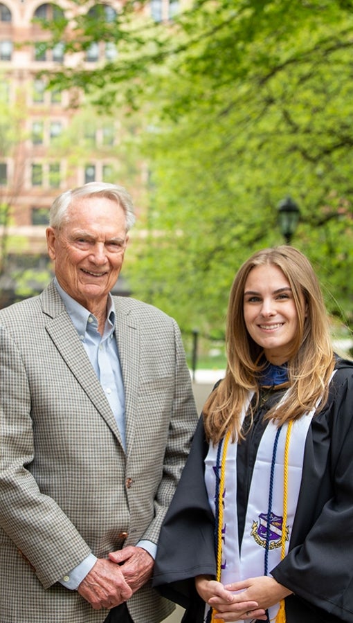 Jim Zurcher stands with Chloe Davis, who wears graduation robes