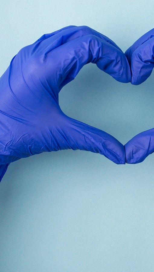gloved hands form heart