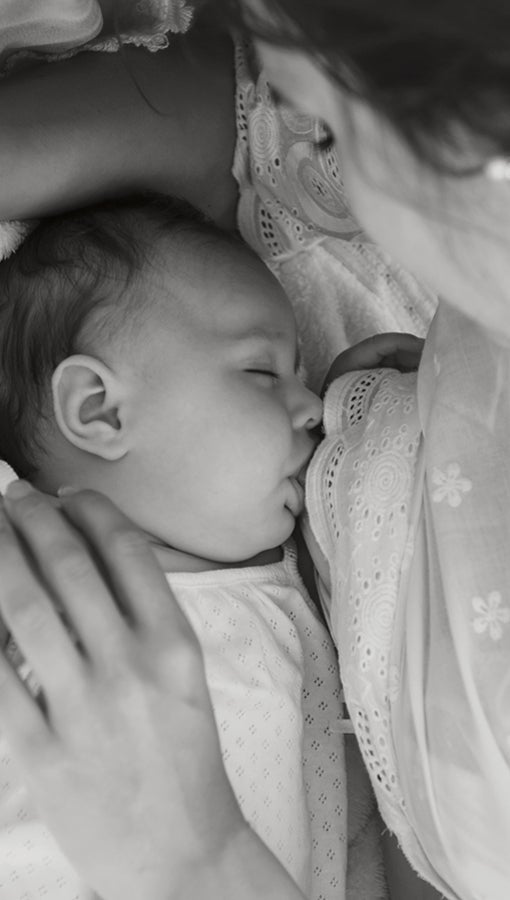 A mother breastfeeds her baby