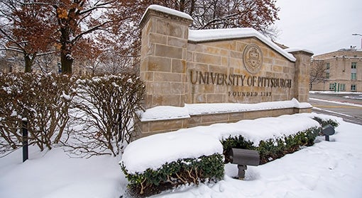 The University of Pittsburgh sign on a snowy day