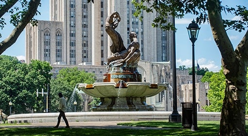 A person walks by a fountain