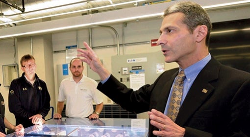 At Benedum Hall, Gregory Reed, director of Pitt's Center for Energy in the Swanson School of Engineering, gathers with students (from left) Andrew Bulman, and Pat Lewis.