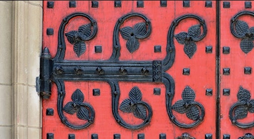 red door with black hardware, leaf motif