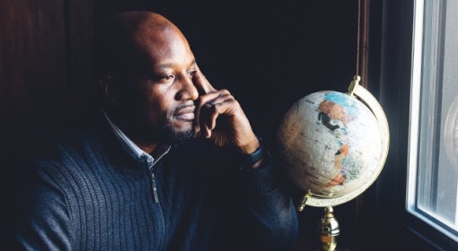 Kenyon Bonner looks out the window, a globe sitting on the window ledge