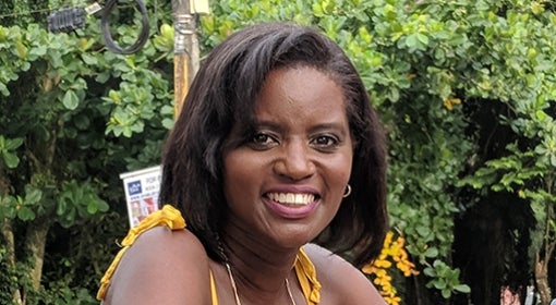 woman wearing yellow spaghetti straps, trees in background