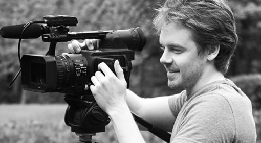 Tom Getty handles a movie camera on set