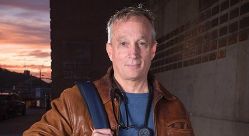 Jim Withers with backpack and stethoscope, ready to practice street medicine