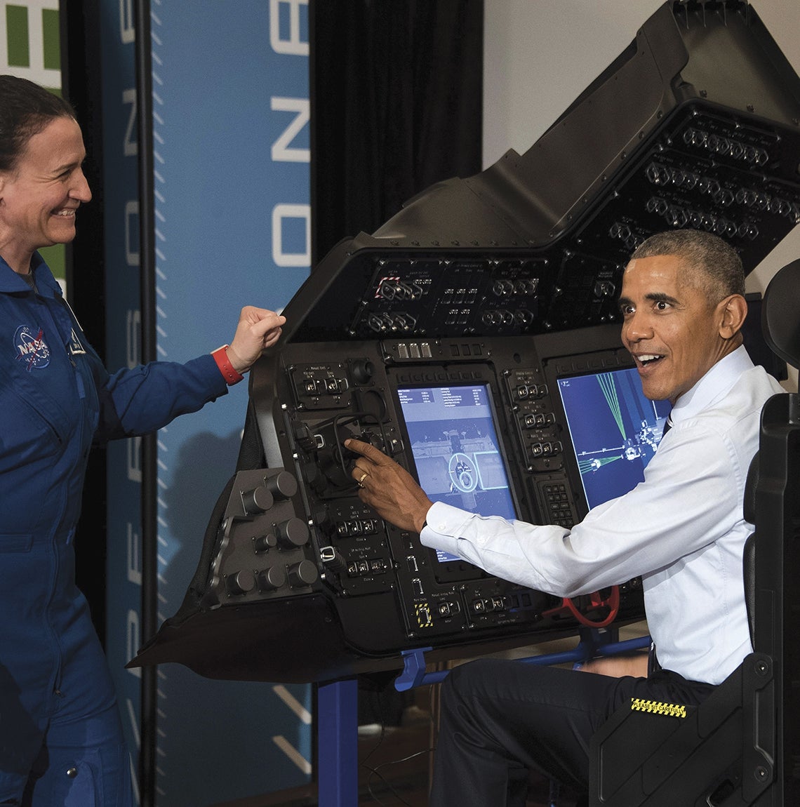 President Obama interacts with NASA equipment.